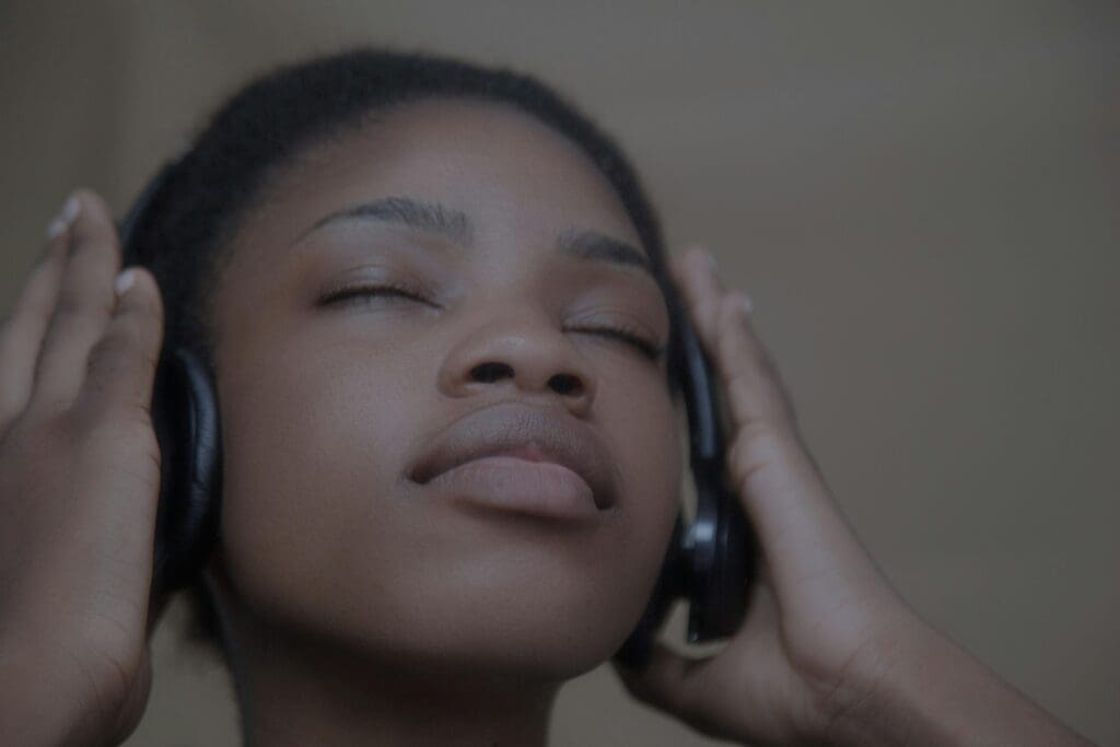 Black woman in headphones engaging in EMDR therapy.